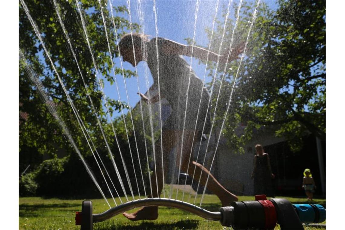 Umweltamt warnt vor Streit ums Wasser in Deutschland Abkühlung im Garten unter einem Rasensprenger. Foto: Karl-Josef Hildenbrand