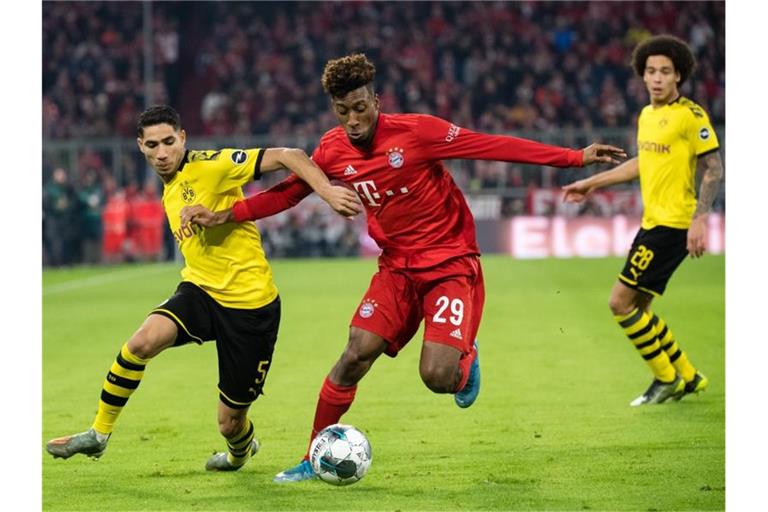 Achraf Hakimi (l) im Zweikampf mit Bayern-Profi Kingsley Coman. Foto: Matthias Balk/dpa