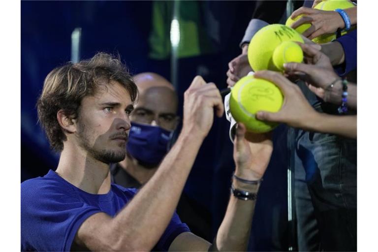 Alexander Zverev (l) gibt nach der ATP-Siegerehrung Autogramme. Foto: Luca Bruno/AP/dpa