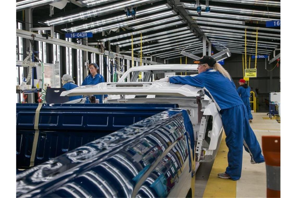 Arbeiter führen in einer Lackiererei von General Motors in Flint eine Endkontrolle durch. Der größte US-Autobauer ist im vergangenen Quartal besonders hart von den branchenweiten Chip-Lieferengpässen getroffen worden. Foto: Ryan Garza, Detroit Free Press/TNS via ZUMA Wire/dpa