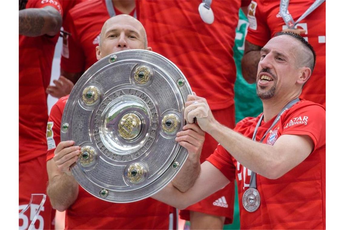 Arjen Robben (l) und Franck Ribéry feiern die deutsche Meisterschaft. Foto: Matthias Balk
