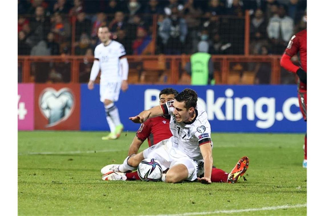 Flicks siebter Streich: DFB-Auswahl gewinnt auch in Armenien Armeniens Taron Woskanjan bringt Florian Neuhaus (M) im Strafraum zu Fall. Foto: Christian Charisius/dpa