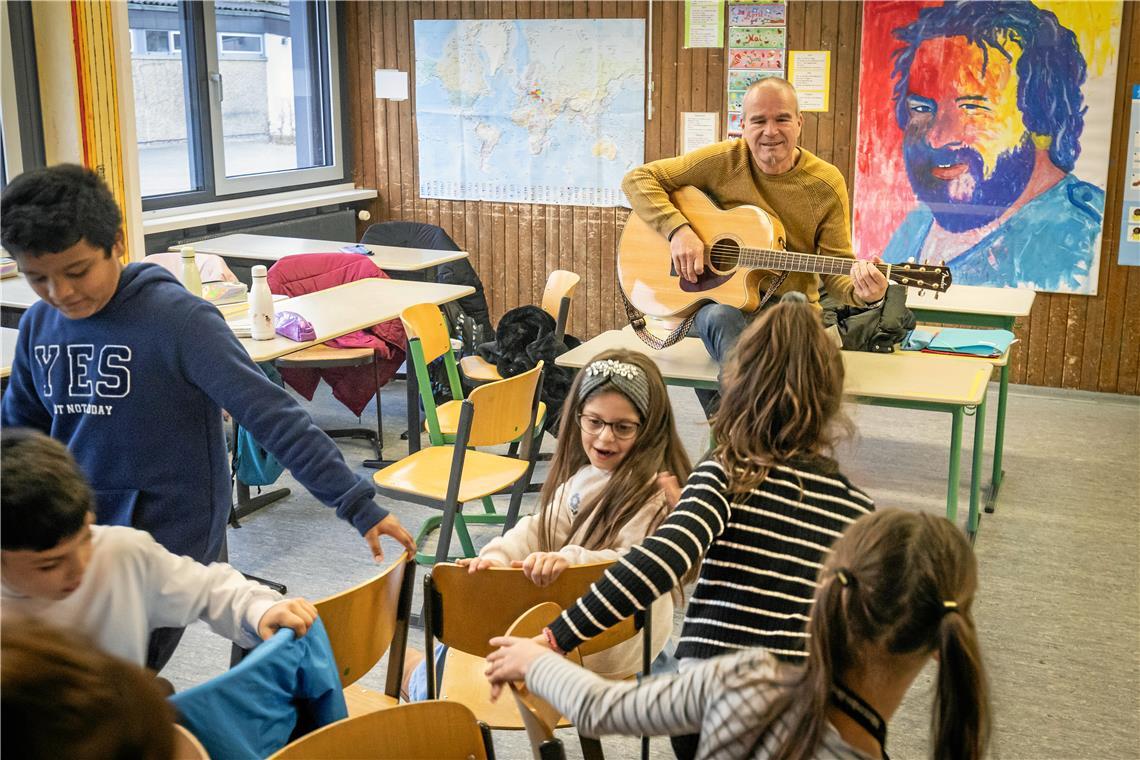 In Vorbereitungsklassen wird spielerisch die deutsche Sprache erlernt Armin Scherhaufer (an der Gitarre) bindet in seinen Unterricht in der Vorbereitungsklasse gerne Musik ein. Foto: Alexander Becher