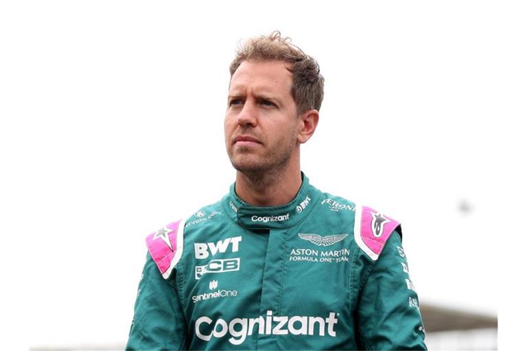 Aston Martin-Pilot Sebastian Vettel steht mit nachdenklicher Miene im Fahrerlager. Foto: Bradley Collyer/PA Wire/dpa