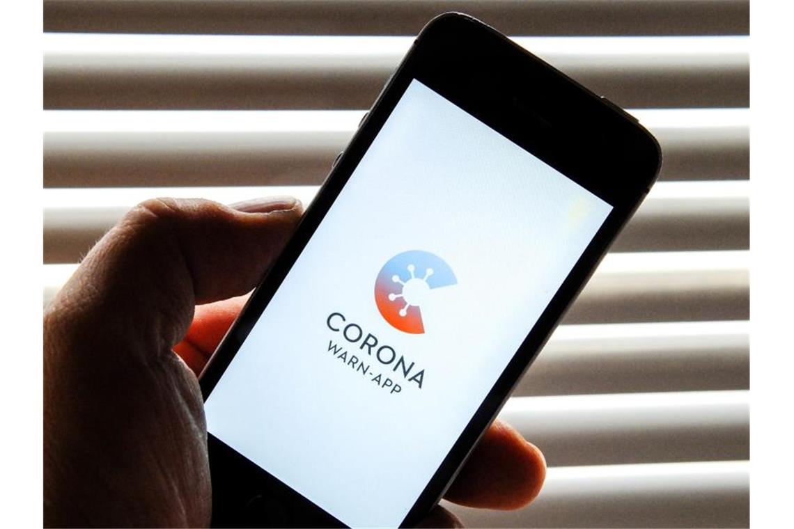 Auf dem Bildschirm eines Apple iPhone SE ist der vom Presse- und Informationsamt der Bundesregierung herausgegebene Startschirm einer Corona Warn-App abgebildet. Foto: Stefan Jaitner/dpa