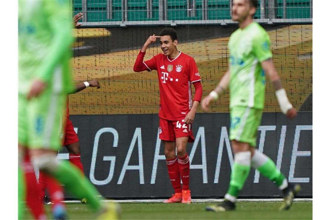 Bayern gewinnt in Wolfsburg - Flick kündigt Abschied an Bayerns Mittelfeldspieler Jamal Musiala (2.v.r) feiert seinen zweiten Treffer mit den Mannschaftskameraden. Foto: Michael Sohn/AP-POOL/dpa