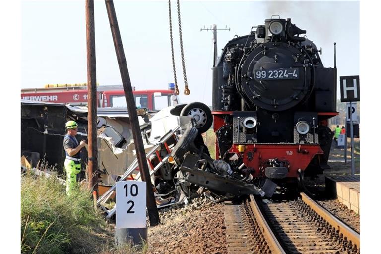 Bergungsarbeiten nach der Kollision der Kleinbahn Molli mit einem Wohnmobil in Wittenbeck. Foto: Bernd Wüstneck/dpa-Zentralbild/dpa