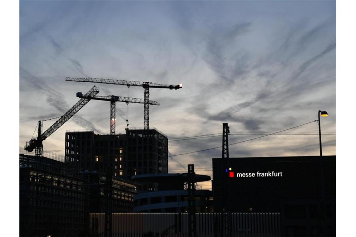 Frankfurter Messe verschiebt weitere Veranstaltungen Blick auf Baukräne am Gelände der Frankfurter Messe am Abend. Foto: Jens Kalaene/dpa/Archivbild