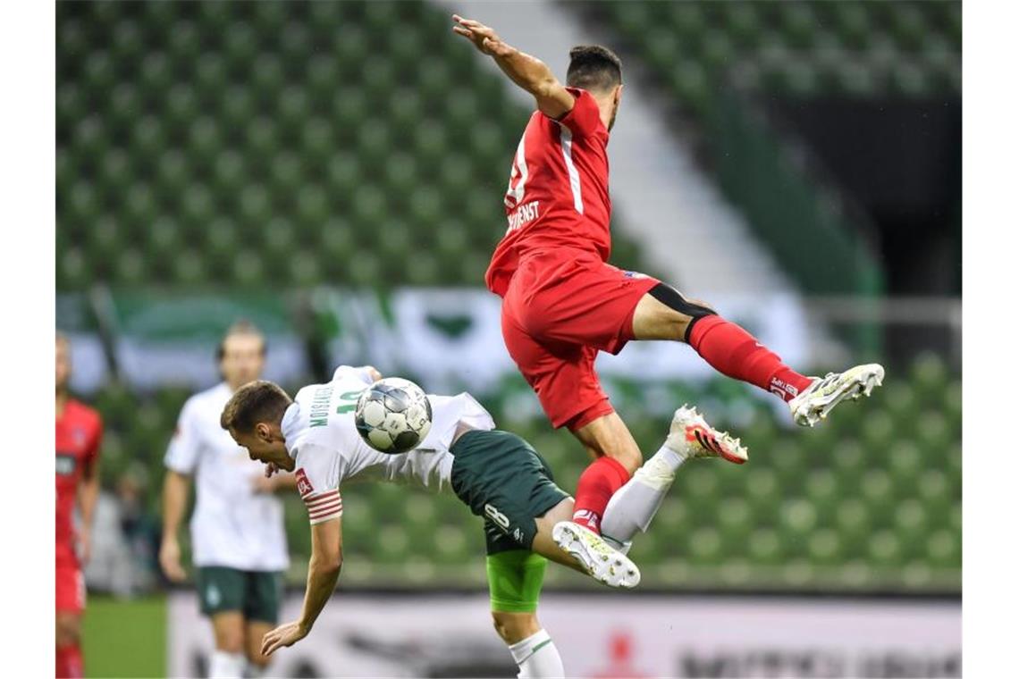 Werder droht weiter der Abstieg: Nullnummer gegen Heidenheim Bremens Niklas Moisander (l) im Zweikampf mit Tim Kleindienst. Foto: Martin Meissner/AP POOL/dpa