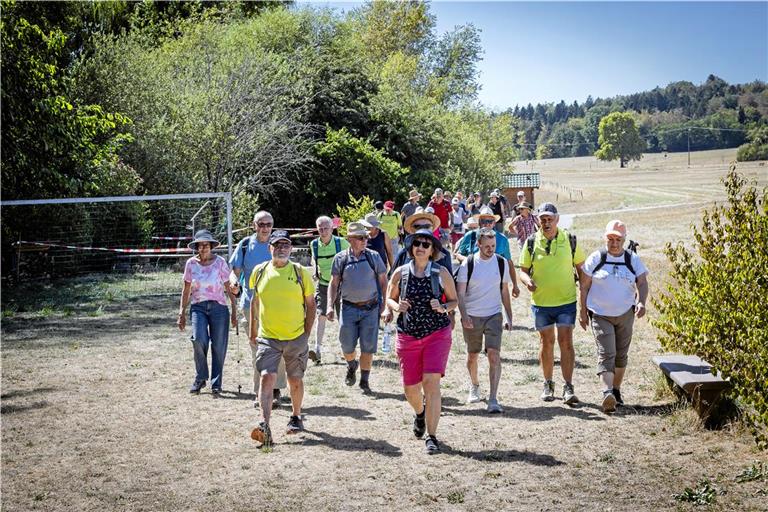 Bürgermeister Kevin Dispan (Dritter von rechts) führt die meist gut behüteten Teilnehmer der Wanderung durch die Gemeinde. Foto: Alexander Becher