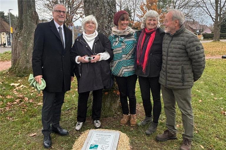 Bürgermeister Reinhold Sczuka (von links) enthüllt zusammen mit Helgard Köhler, Silvia Bona, Susanne Bona und Wilfried Bauer die Plakette an der Friedenslinde. Foto: Tänzer