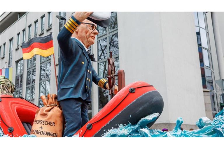 Bundeskanzler Friedrich Merz CDU als Schlauchboot-Kapitän (Motivwagen für den Rosenmontagsumzug 2026 in Mainz): „Fritze auf großer Fahrt: Der Kapitän in großer Not, es droht zu sinken, Fritzes Boot. Doch hat man sich, weils nur gekracht, in diese Lage selbst gebracht."