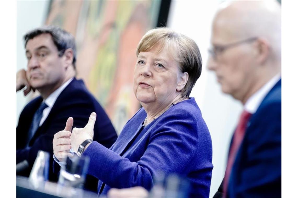 Corona-Regeln in Deutschland werden leicht gelockert Bundeskanzlerin Angela Merkel, Bayerns MInisterpräsident Markus Söder (l) und Hamburgs Erster Bürgermeister Peter Tschentscher geben nach der Videokonferenz der Regierungschefs eine Pressekonferenz. Foto: Kay Nietfeld/dpa Pool/dpa
