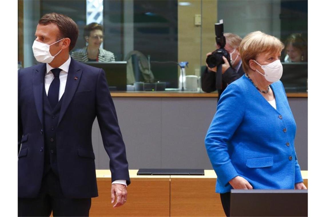 Bundeskanzlerin Merkel und der französische Präsident Macron zusammen beim EU-Gipfel. Foto: Francois Lenoir/Reuters Pool/AP/dpa