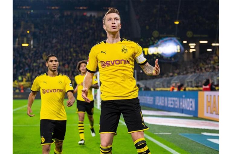BVB-Kapitän Marco Reus (M) erzielte dem Dortmunder Siegtreffer. Foto: Guido Kirchner/dpa
