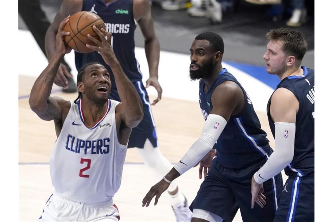 Mavericks verlieren erstes Playoff-Heimspiel in der NBA Clippers-Flügelspieler Kawhi Leonard (l) setzt sich gegen die Mavs Tim Hardaway Jr. (M.) und Luka Doncic durch. Foto: Tony Gutierrez/AP/dpa
