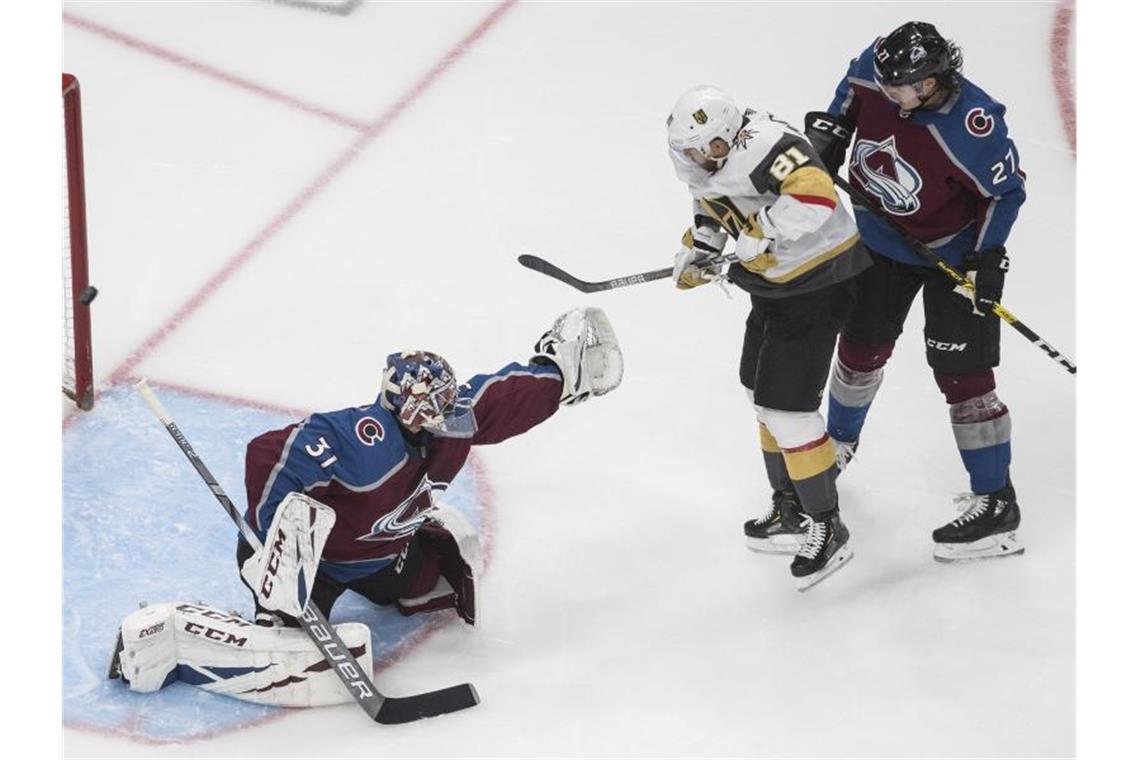 Grubauer vergibt Chance auf Nummer Platz eins für Playoffs Colorados Torhüter Philipp Grubauer (l) mit Ryan Graves (r) in Aktion gegen Jonathan Marchessault von den Vegas Golden Knights. Foto: Jason Franson/The Canadian Press/AP/dpa