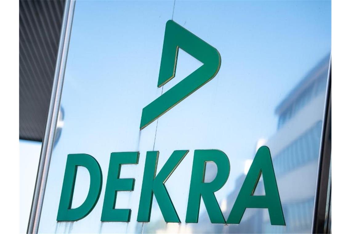 Das Logo der DEKRA steht am Gebäude der DEKRA in Stuttgart. Foto: Fabian Sommer/dpa