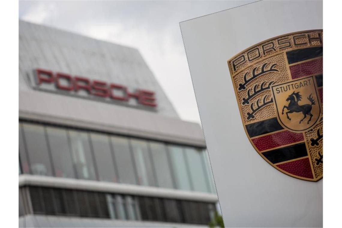 Porsche verzeichnet deutlich angezogene Nachfrage Das Porsche Logo ist vor einem Gebäude des Automobilherstellers zu sehen. Foto: Christoph Schmidt/dpa