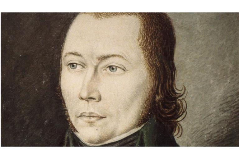 Das Porträt zeigt den „Schinderhannes. Gemalt wurde es 1803 vom kurpfälzischen Maler und Grafiker Karl Matthias Ernst. Genetische Analysen ermöglichten nun auch die Bestimmung seiner tatsächlichen Augen-, Haar- und Hautfarbe. Die Daten deuten darauf hin, dass er braune Augen, dunkle Haare und einen eher blassen Hautton hatte.