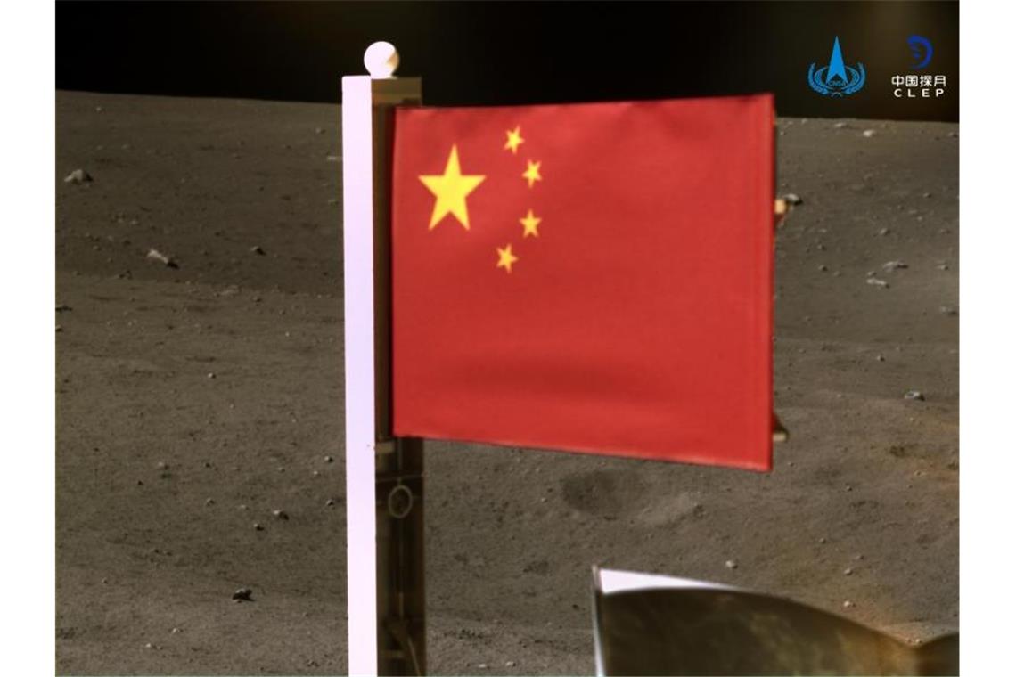 Das von der Nationalen Raumfahrtbehörde Chinas (CNSA) veröffentlichte Bild zeigt Chinas Nationalflagge, die von der Sonde „Chang'e 5“ auf dem Mond entfaltet wurde. Das Bild wurde vor Beginn der Rückkehr mit Mondproben von einer Panoramakamera an Bord des Landegeräts der Sonde aufgenommen. Foto: CNSA/XinHua/dpa