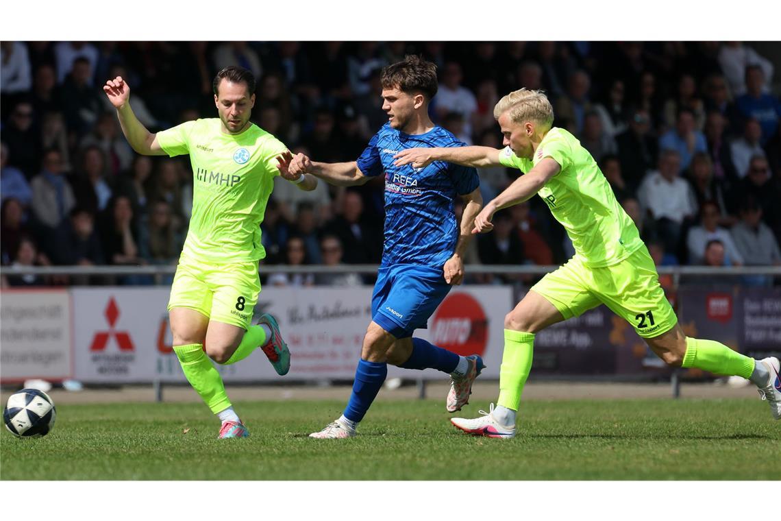 David Tomic (Kickers), Lukas Laupheimer (SGV Freiberg), Per Lockl (Kickers) im Kampf um den Ball (von links).