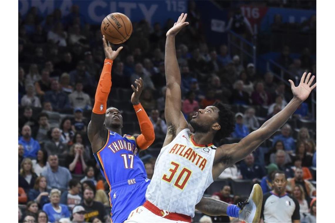 Dennis Schröder (l) gewann mit Oklahoma City Thunder zum vierten Mal in Folge. Foto: Kyle Phillips/AP/dpa