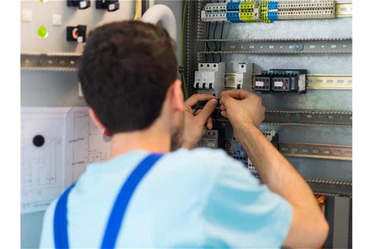 Der 19-jährige Mohammad aus Afghanistan arbeitet in einem Leipziger Ausbildungszentrum von Siemens an der Verdrahtung eines Schaltschranks. Foto: Monika Skolimowska/dpa-Zentralbild/dpa