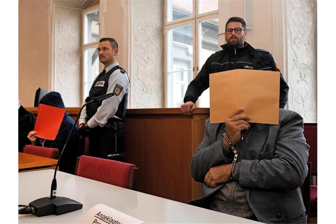 Der Angeklagte sitzt mit gefesselten Händen auf der Anklagebank. Foto: Stefan Puchner/dpa