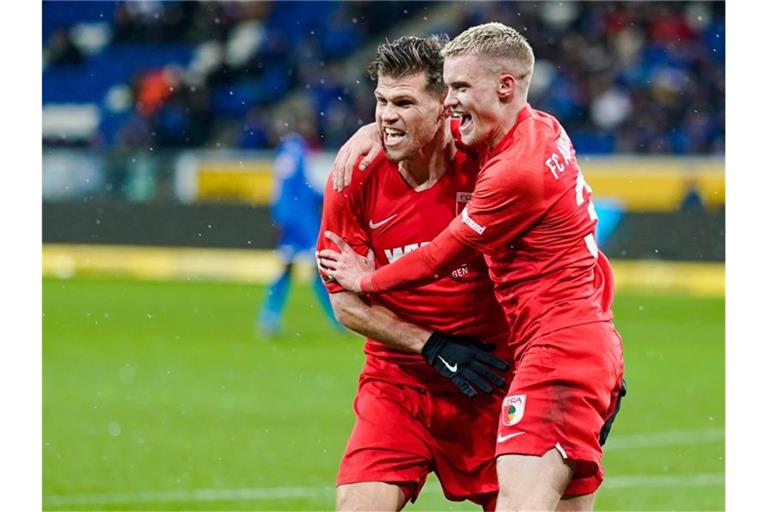 Der Augsburger Torschütze Philipp Max (r) feiert mit Vorbereiter Florian Niederlechner. Foto: Uwe Anspach/dpa