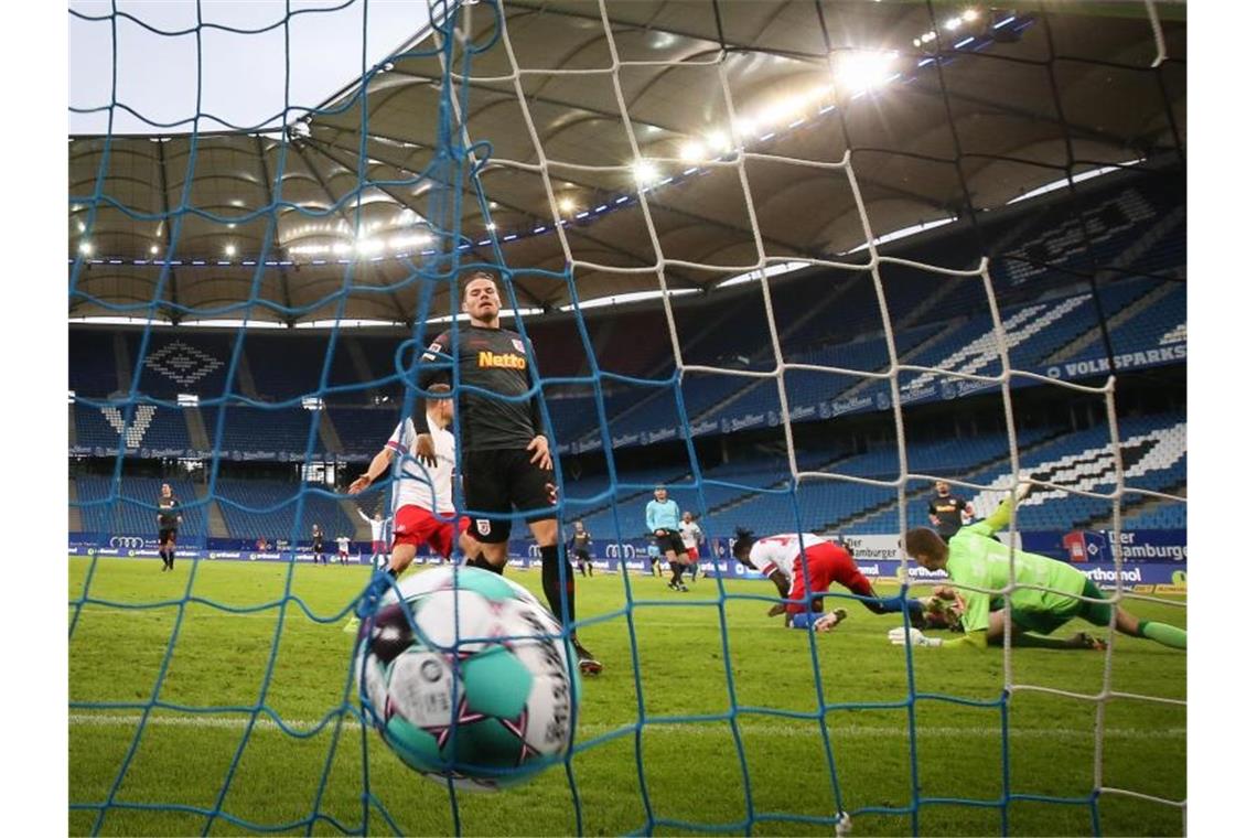 Lockdown-Verlängerung lässt Sorgen im Sport wachsen Der Ball in Deutschlands-Topfußball-Ligen rollt weiter vor leeren Rängen. Foto: Christian Charisius/dpa