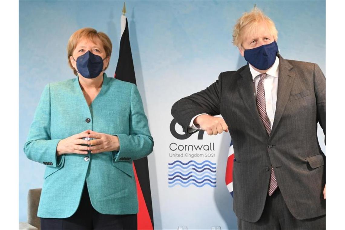 G7 will ärmeren Ländern mit 2,3 Milliarden Impfdosen helfen Der britische Premierminister Boris Johnson gestikuliert bei dem Fotoshooting mit Angela Merkel. Foto: Stefan Rousseau/PA Wire/dpa