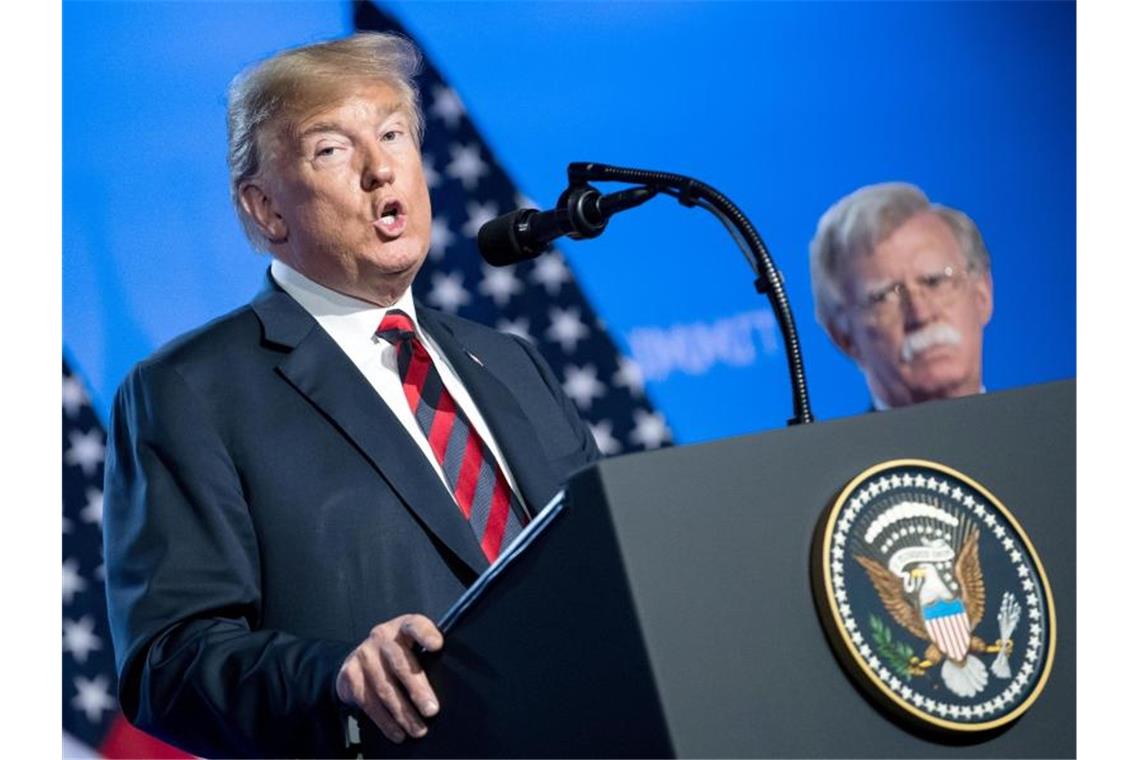 Der damalige Sicherheitsberater John Bolton (r) steht während einer Pressekonferenz neben US-Präsident Donald Trump (Archiv). Foto: Bernd von Jutrczenka/dpa