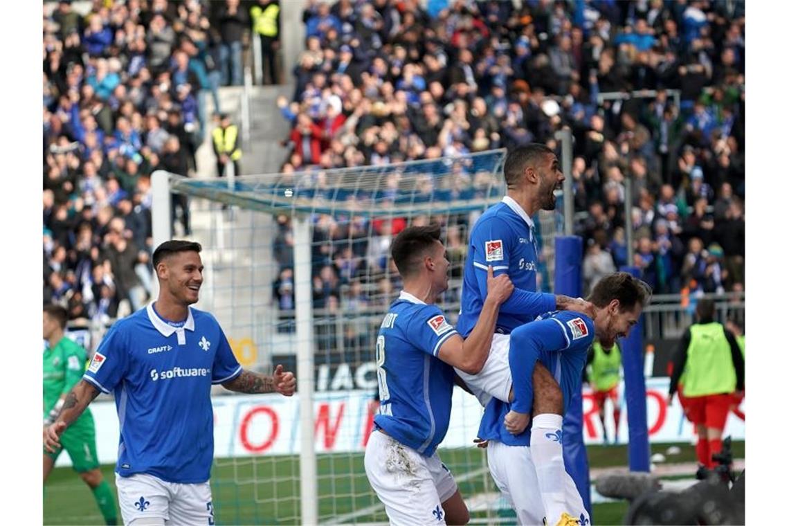 Der Darmstädter Immanuel Höhn (r) jubelt über sein Tor zum 1:0 mit den Mannschaftskameraden. Foto: Hasan Bratic/dpa