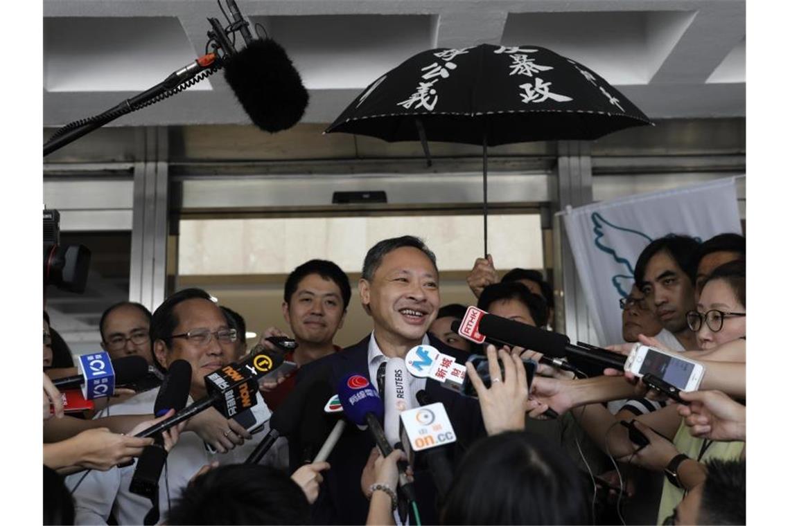 Hongkong lässt Protest-Anführer frei - Neue Demos geplant Der Juraprofessor Benny Tai (M) durfte gegen eine Kaution von umgerechnet etwa 11.500 Euro vorzeitig die Haftanstalt verlassen. Foto: Vincent Yu/AP