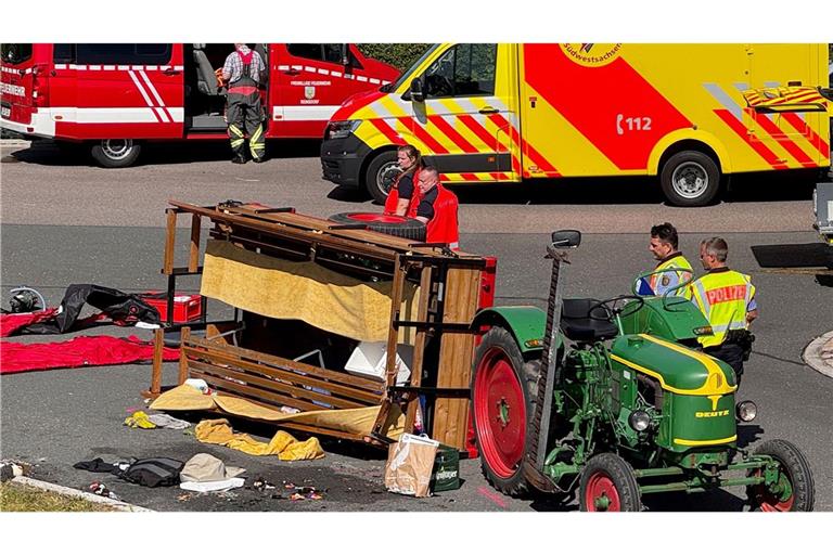 Der kleine, offene Kutschenanhänger mit zwei gegenüberliegenden Holzbänken war von einem Traktor gezogen worden.