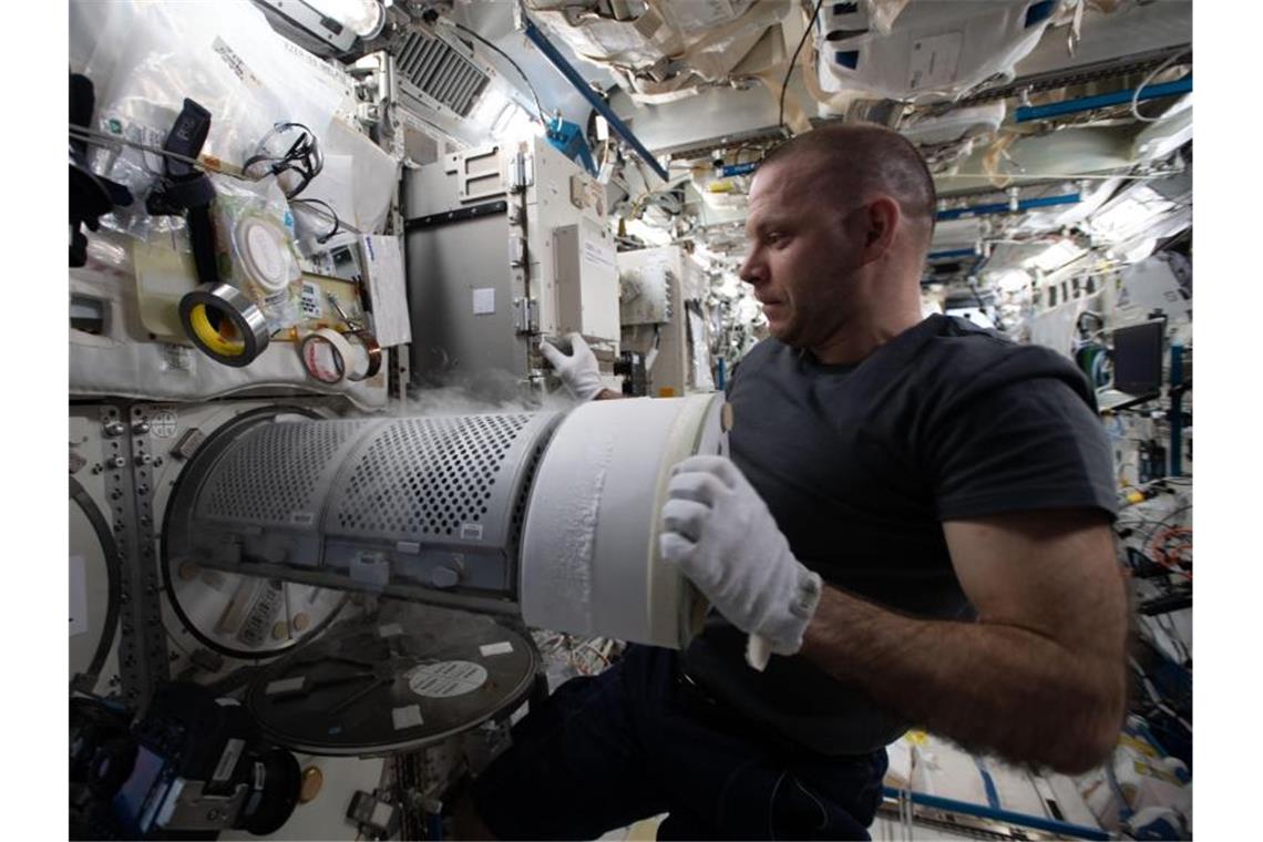 Der Kosmonaut Iwan Wagner überführt biologische Proben in einen wissenschaftlichen Gefrierschrank an Bord der Internationalen Raumstation (ISS). Foto: NASA/dpa