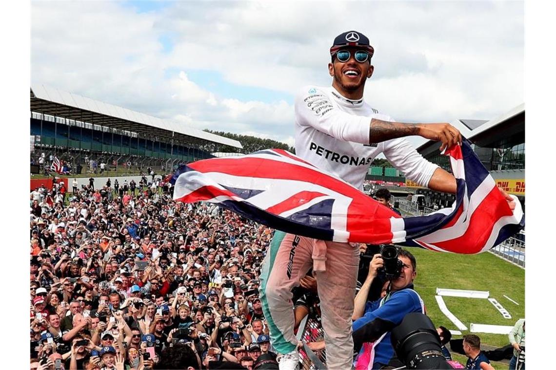 Der Mercedes-Formel-1-Pilot Lewis Hamilton feiert seinen Sieg mit dem Publikum auf dem Silverstone Circuit. Foto: David Davies/PA Wire/dpa