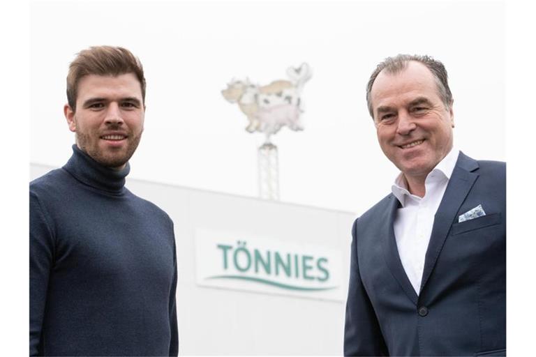 Der Miteigentümer der Unternehmensgruppe Tönnies Holding, Clemens Tönnies (r), und sein Sohn und Tönnies-Mitgesellschafter Maximilian Tönnies (l) stehen vor einem Firmengebäude mit dem Geschäftslogo in Rheda-Wiedenbrück. Foto: Friso Gentsch/dpa