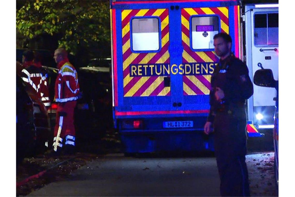 Der Rettungsdienst steht am Einsatzort in Lübeck, wo ein Mann durch Schüsse bei einem Polizeieinsatz gestorben ist. Foto: -/TNN/dpa