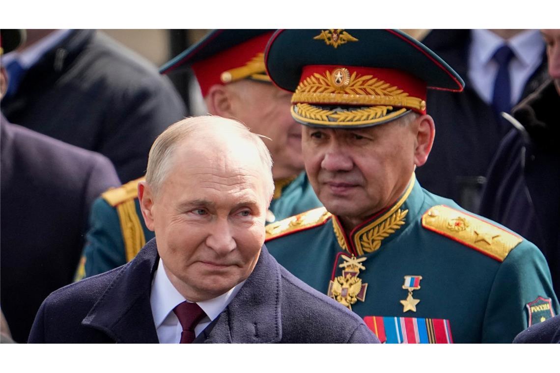 Der russische Präsident Wladimir Putin (l) und der russische Verteidigungsminister Sergej Schoigu (r) verlassen den Roten Platz nach der Militärparade zum Tag des Sieges.