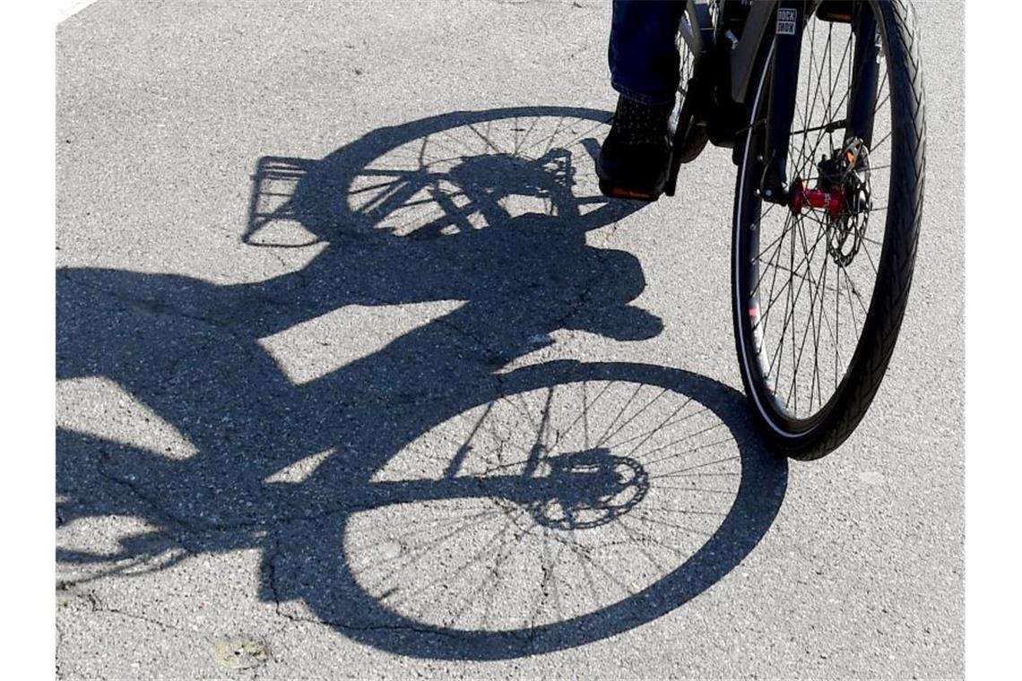 Sorgen um Pedelecfahrer: Starke Zunahme der Unfälle Der Schatten eines E-Bikes ist neben dem Rad zu sehen. Foto: Uli Deck/dpa/Archiv