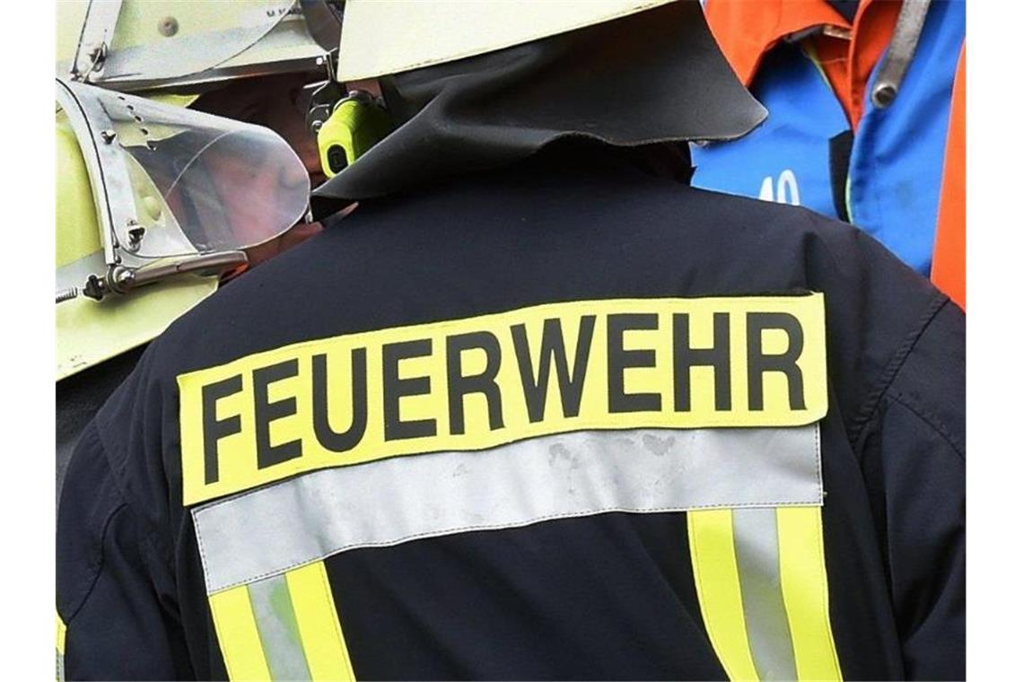 Der Schriftzug „Feuerwehr“ stehtan der Jacke eines Feuerwehrmannes. Foto: picture alliance / dpa/Symbolbild