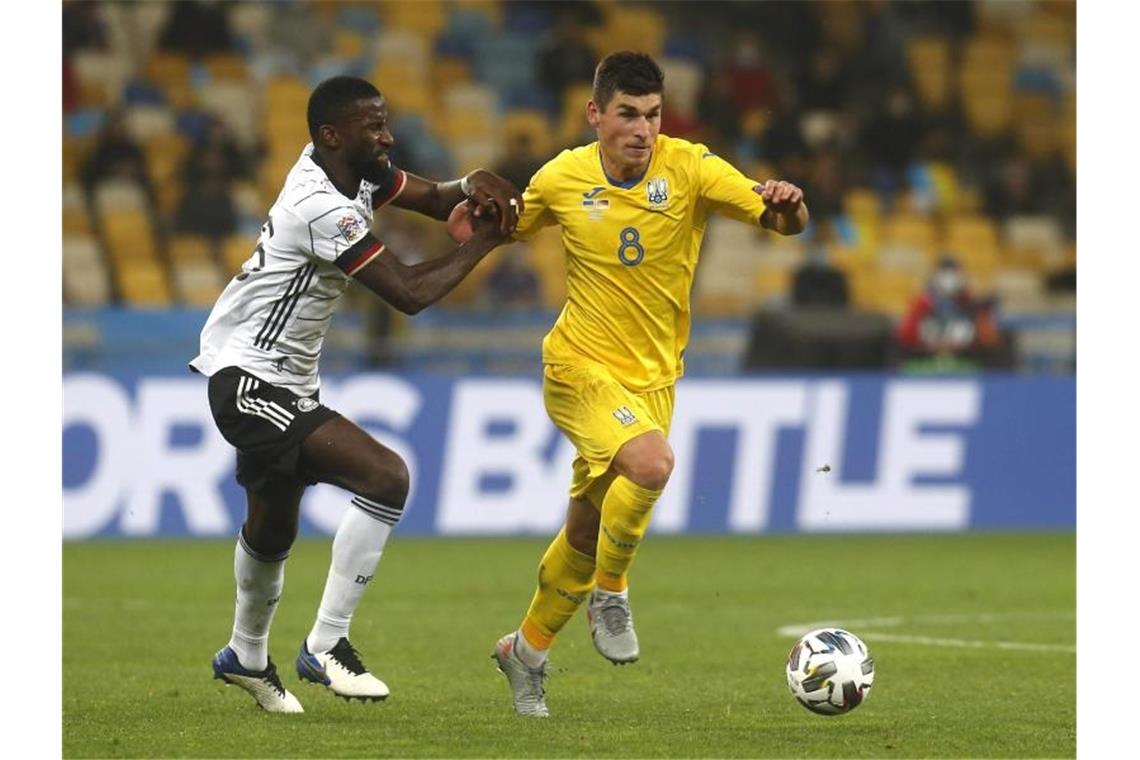 Der Ukrainer Ruslan Malinowskyj (r) versucht den Ball vor Antonio Rüdiger abzuschirmen. Foto: Efrem Lukatsky/AP/dpa