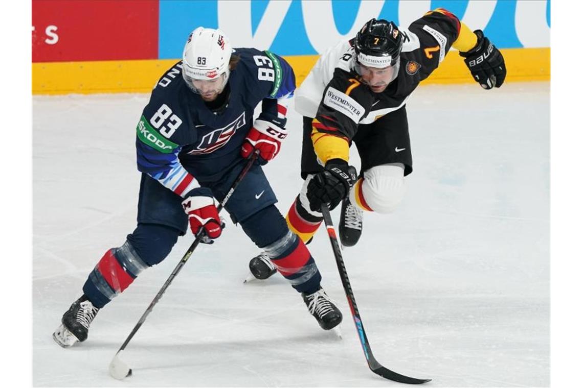 Tränen statt Medaille: Starke WM endet mit Lehrstunde Der US-Amerikaner Conor Garland (l) und Deutschlands Maximilian Kastner kämpfen um den Puck. Foto: Roman Koksarov/dpa