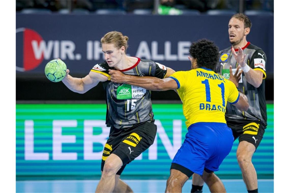 Deutsche Handballer mit überzeugendem Olympia-Test Deutschlands Juri Knorr (l) im Duell mit dem Brasilianer Cleber Andrade. Foto: Sascha Klahn/dpa