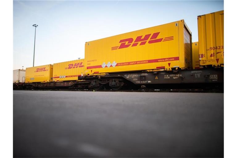 DHL-Container stehen im Güterterminal in Langerfeld in Wuppertal auf Waggons. Foto: Jonas Güttler/dpa