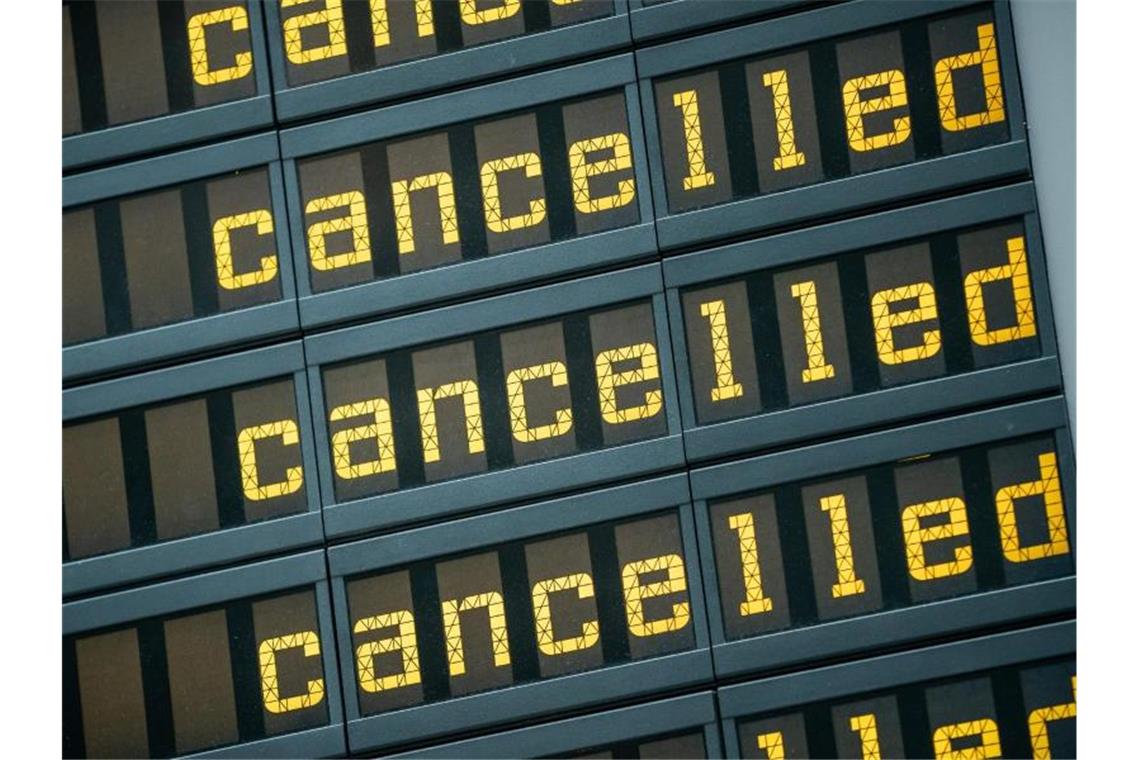 Die Anzeigetafel eines Flughafen zeigt viele Flüge als gestrichen an. Foto: Michael Kappeler/dpa