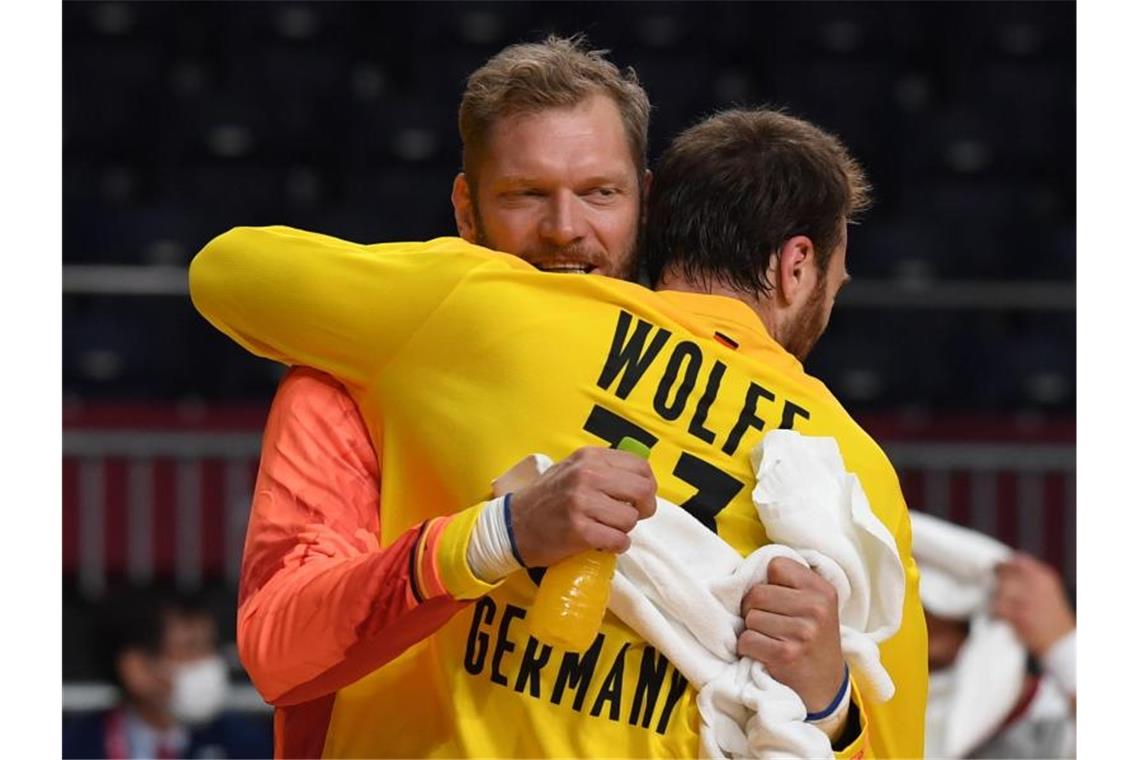 Die deutschen Torhüter Johannes Bitter (l) und Andreas Wolff feiern den Sieg. Foto: Swen Pförtner/dpa
