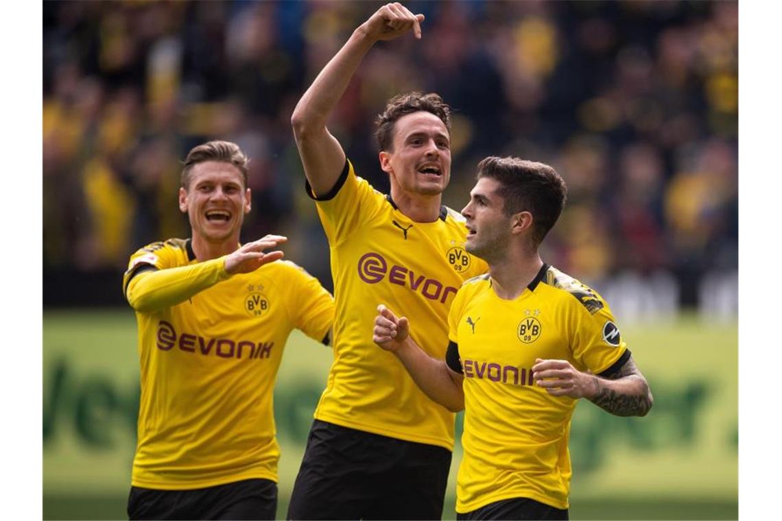 Titelentscheidung vertagt - 96 und Nürnberg steigen ab Die Dortmunder Spieler feiern das 1:0 gegen Fortuna Düsseldorf. Foto: Marius Becker